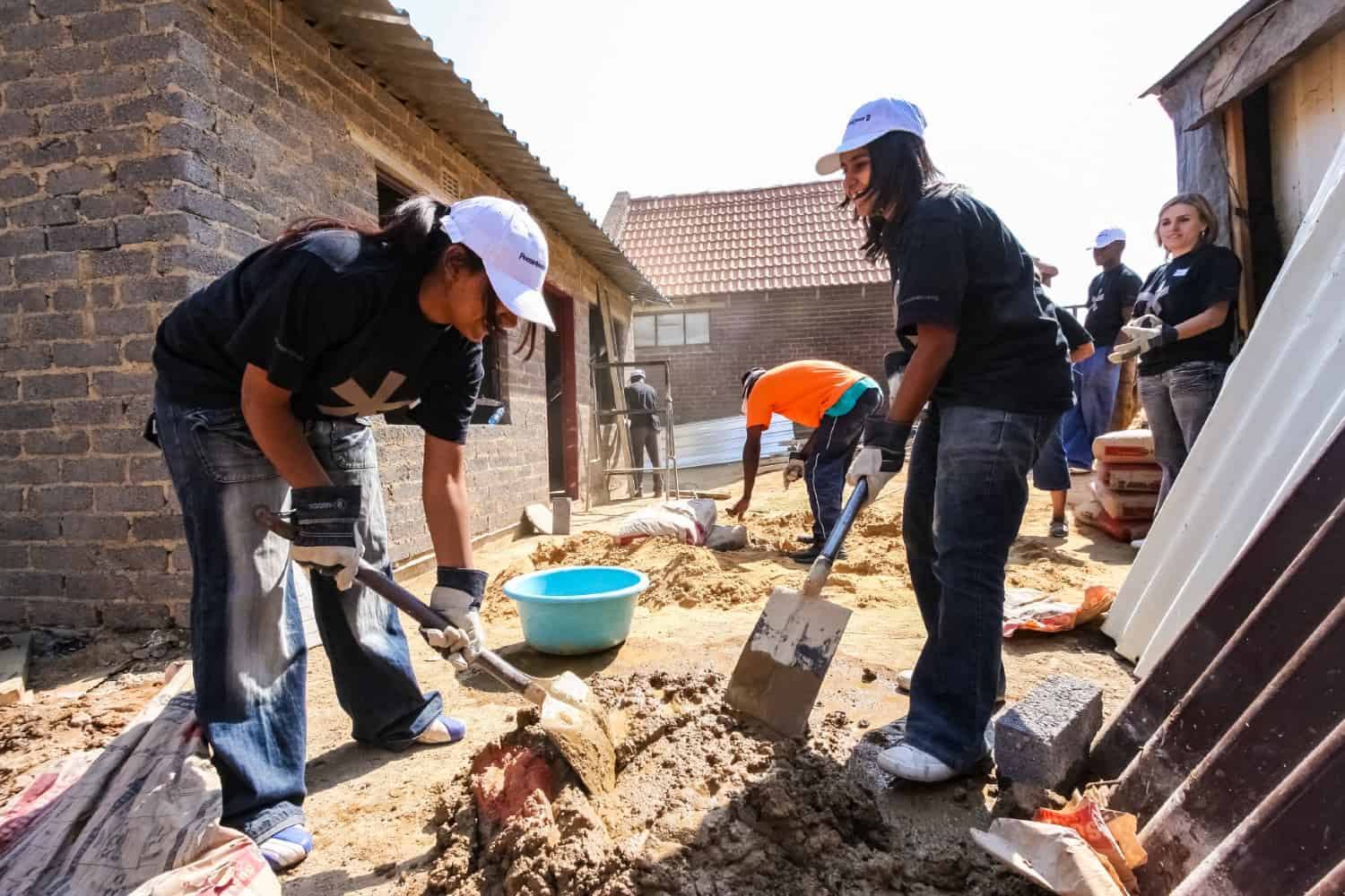 stock-photo-soweto-south-africa-september-diverse-community-outreach-program-mixing-cement-for-1711168819